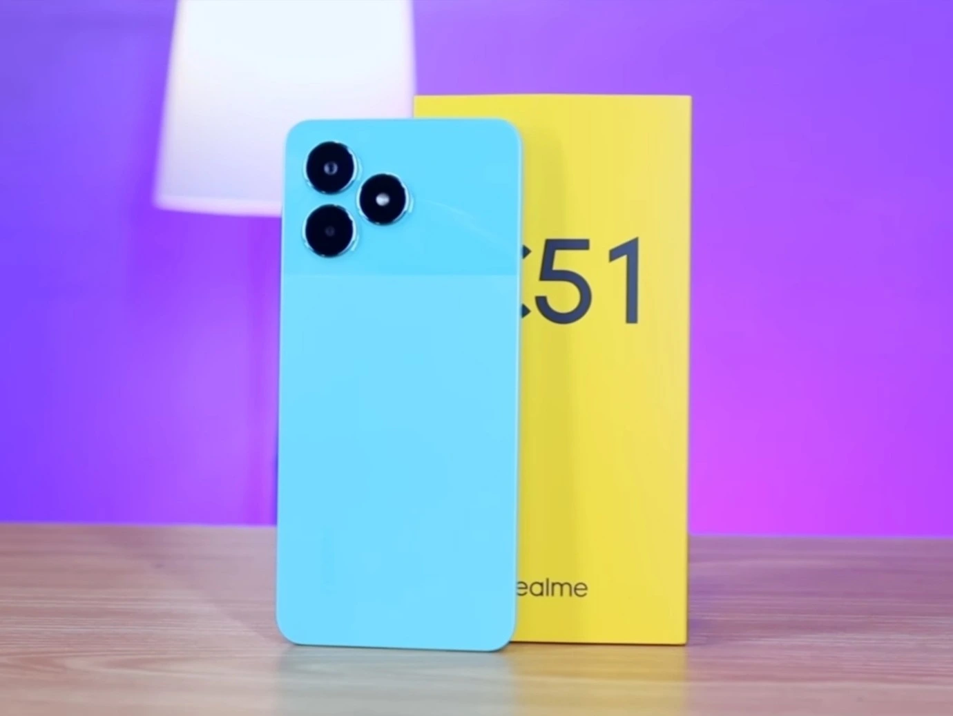 Realme C51 smartphone in mint green color with retail box.